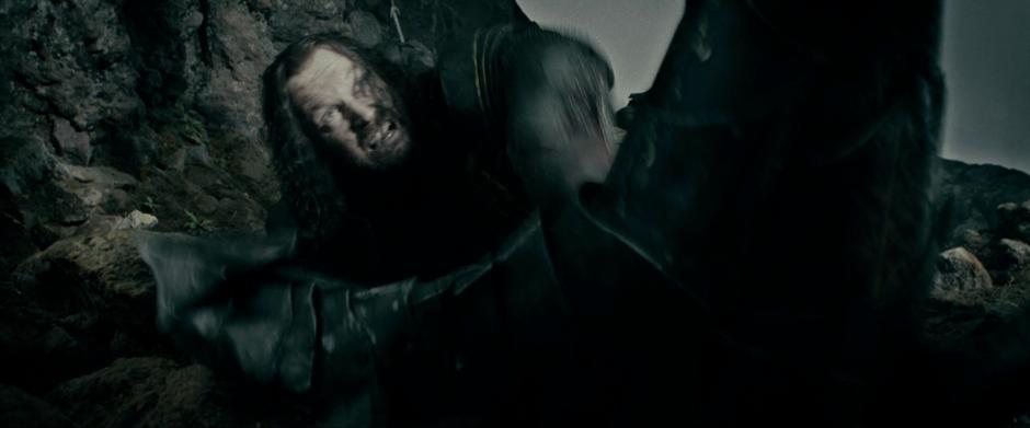 Sauron steps on Elendil's sword Narsil when Isildur attempts to grab it.