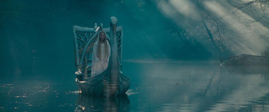 Galadriel rides a boat to meet with the Fellowship.