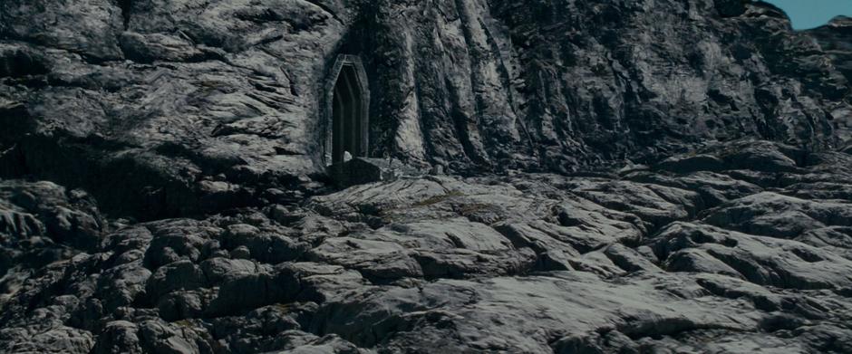 The Fellowship runs out of the Mines of Moria. The steps were constructed on location, while the door and the cliff face were both added digitally.