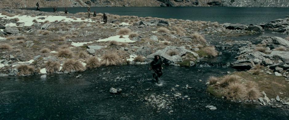 The Fellowship walks around a lake in the Dimrill Dale.