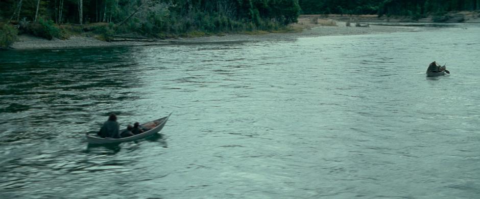 The Fellowship paddles down the river.