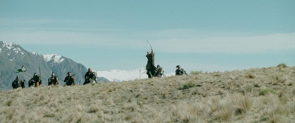 Legolas fires and arrow at the oncoming Wargs as the rest of the soldiers come up behind.