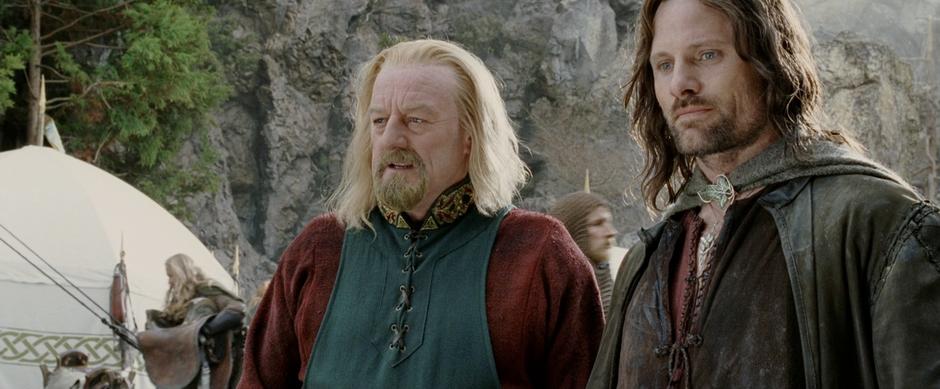 Aragorn and Theoden look down at the troops gathering for war.