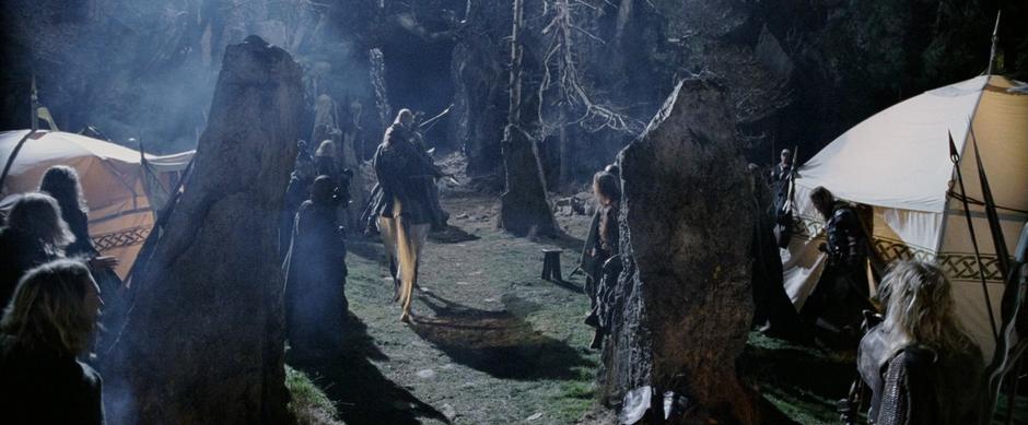 Aragorn, Legolas, and Gimli ride out of the camp towards the Dimholt Road.