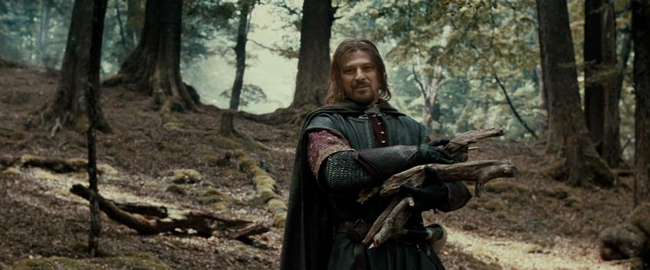 Boromir comes upon Frodo while gathering wood on the hillside.