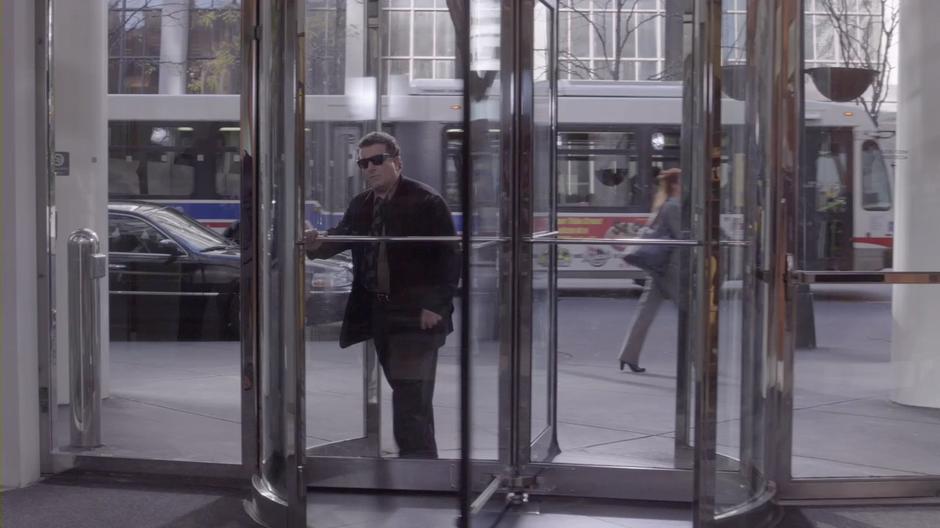 Victor Dubenich walks into the office lobby for his meeting with Sophie.