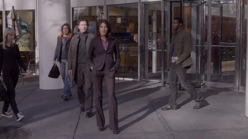 The Leverage team walks away from the office building after conning Victor Dubenich into accepting their office with the Nigerians.