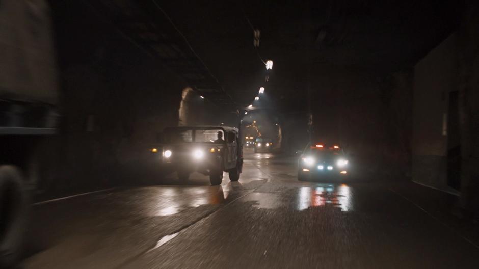 Evacuating cars race through the tunnels on their way out of the collapsing facility.