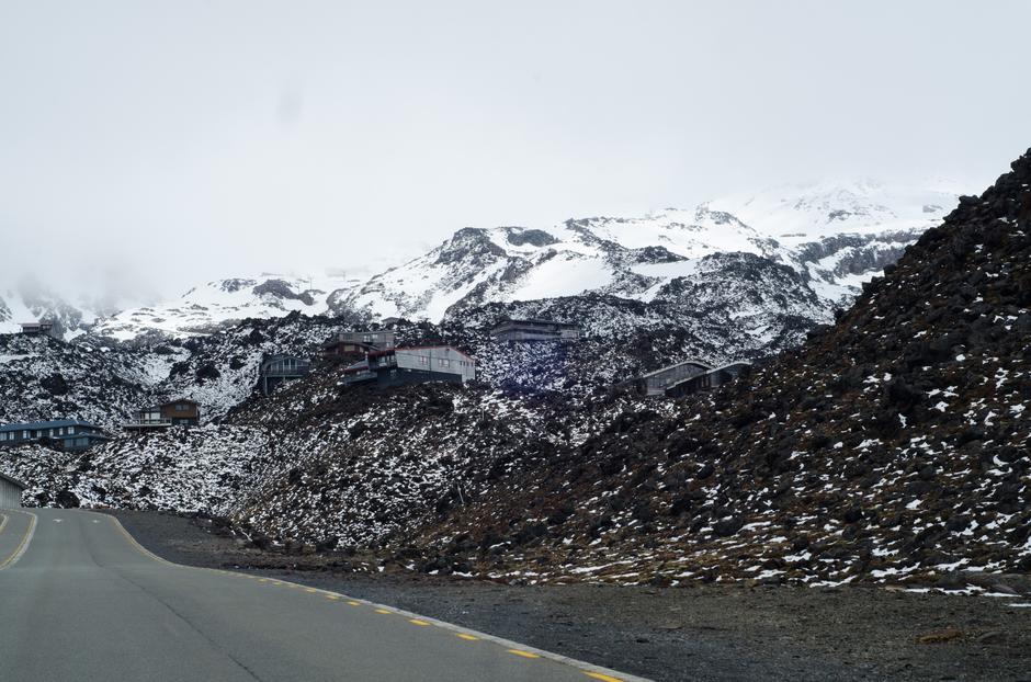 From the entrance road looking up at the mountain lodges with the mountain receding into the clouds.