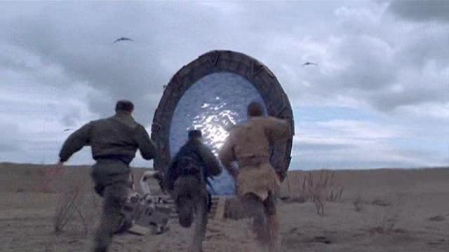 Sam, Martouf, and Jacob Carter run for the Stargate while under fire from the Goa'uld.