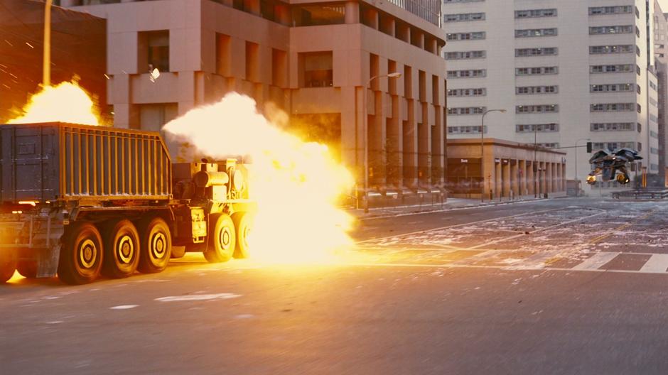 Bruce fires upon the bomb truck with the Bat.