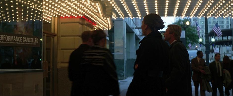 Rachel and Harvey Dent look at the announcement posted out front of the theatre.