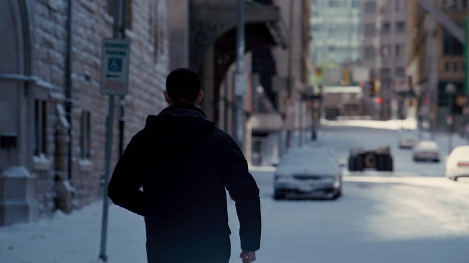 Blake walks across the street as one of the tumblers drives off down the road.