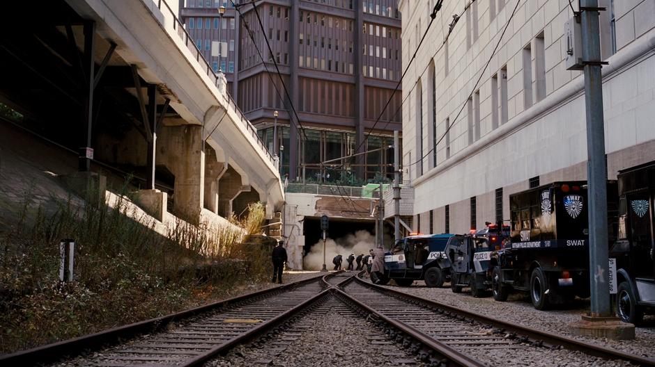 Foley and the remaining police officers take cover as the tunnel collapses.