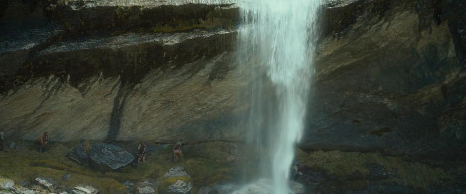 Thorin's party hikes beneath a waterfall on their way up into the mountains.