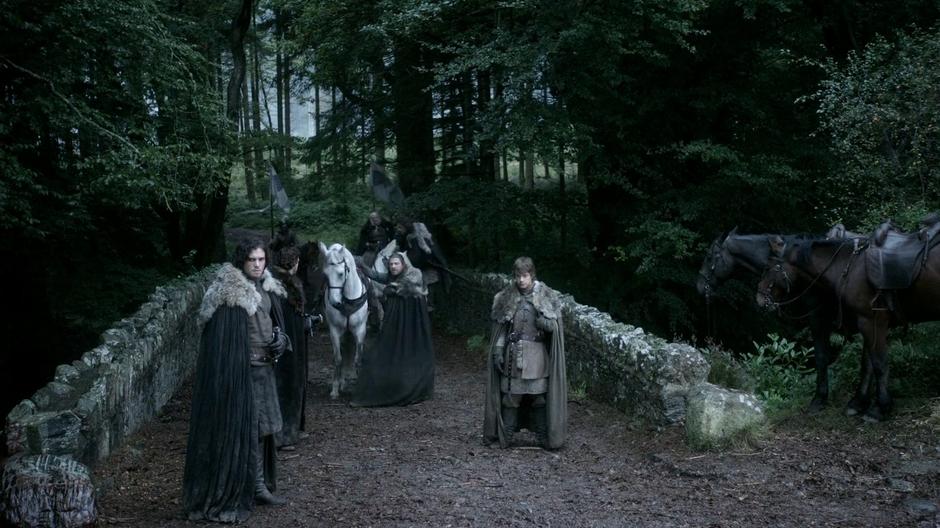 The Starks see a animal carcass in the path as they cross a bridge.