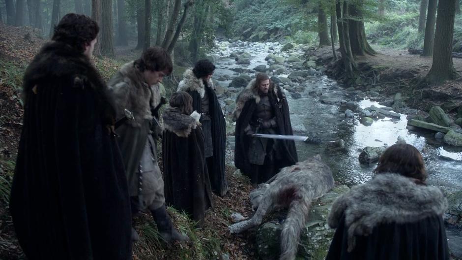 The Stark boys examine the dead dire wolf.