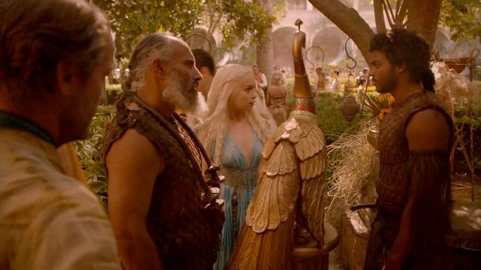 Daenerys talks to some of her Dothraki at the party.