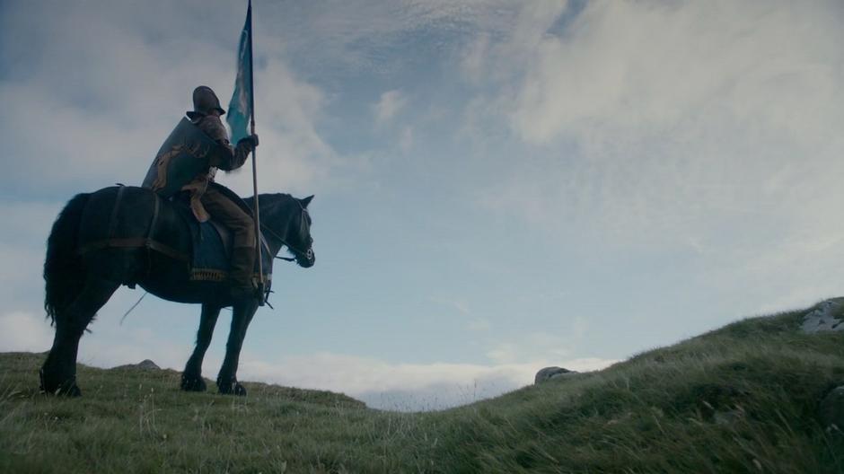 One of Renly's standard sits atop his horse on the hill.