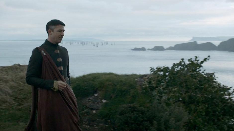 Littlefinger walks through the camp.