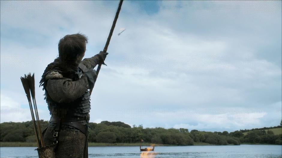 Edmure fires a burning arrow at the funeral boat.