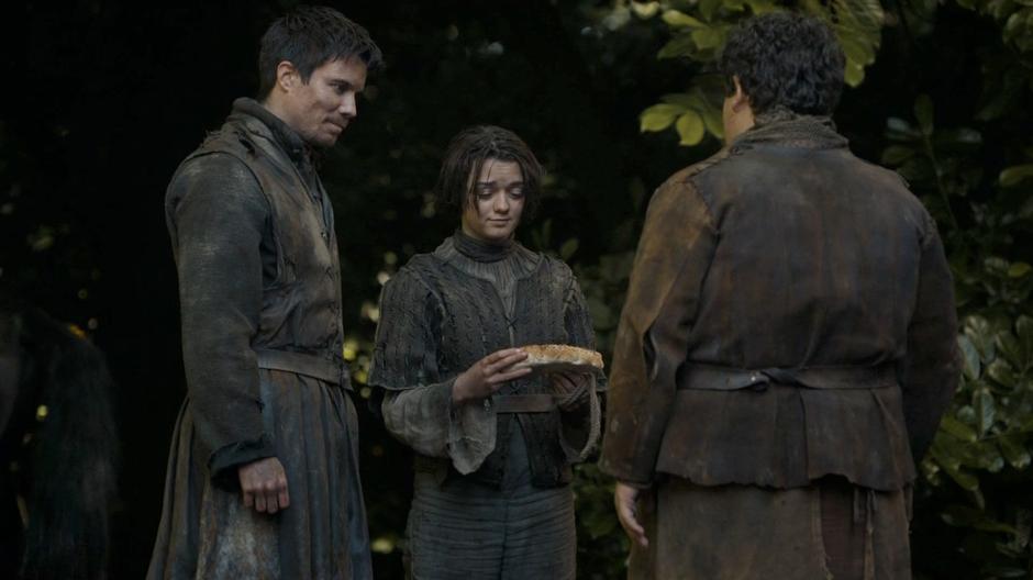 Gendry watches as Arya examines the wolf shaped bread given to her by Hot Pie.