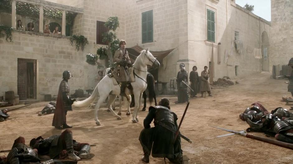 Jaime gets on his horse after injuring Ned.