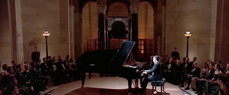 Irene and Vincent watch a twelve-fingered pianist play.