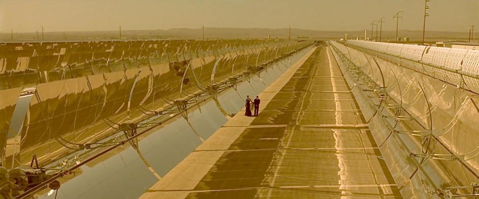 Irene and Vincent wander through the solar collectors the morning after their date.