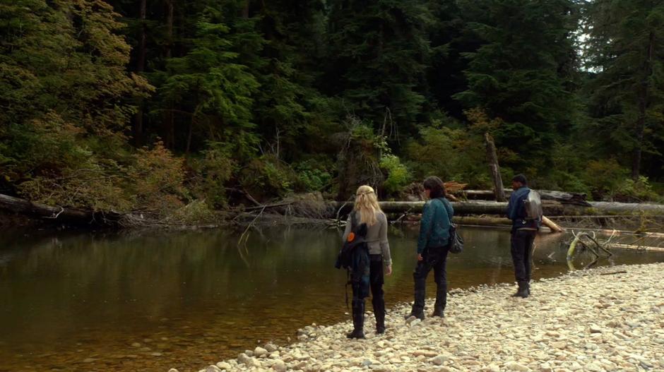 Clarke, Finn, and Wells search the river for the plants they need.