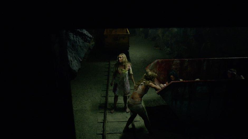 Anya examines the injured grounders while Clarke looks around the tunnel.