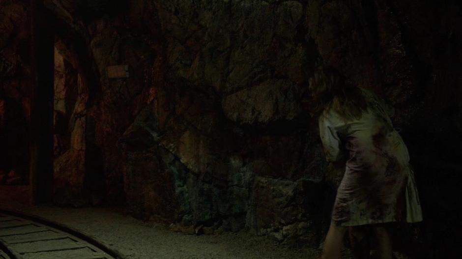 Clarke sees some reapers approaching down the tunnel.