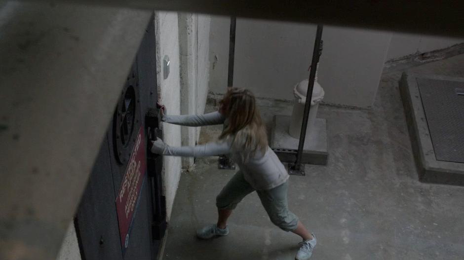 Clarke tries to get the security door open.