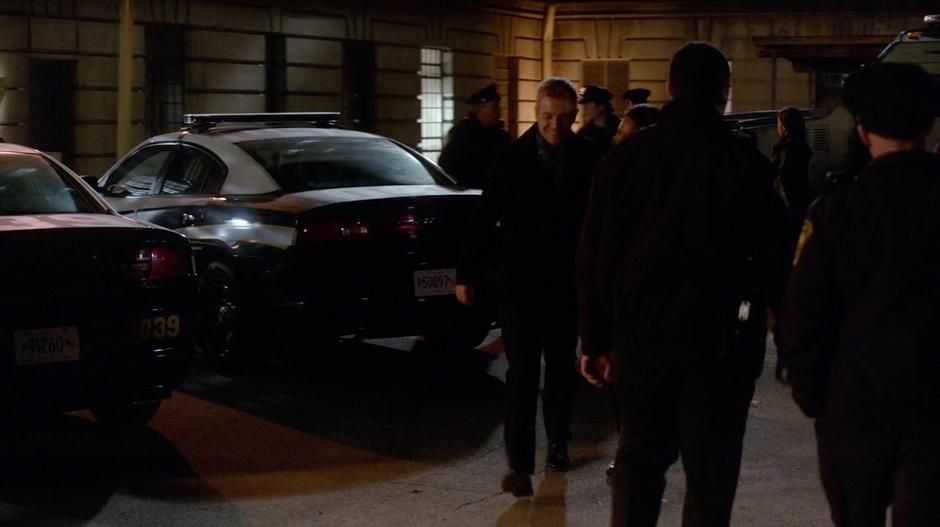 Eddie walks with Iris through the police station parking lot.