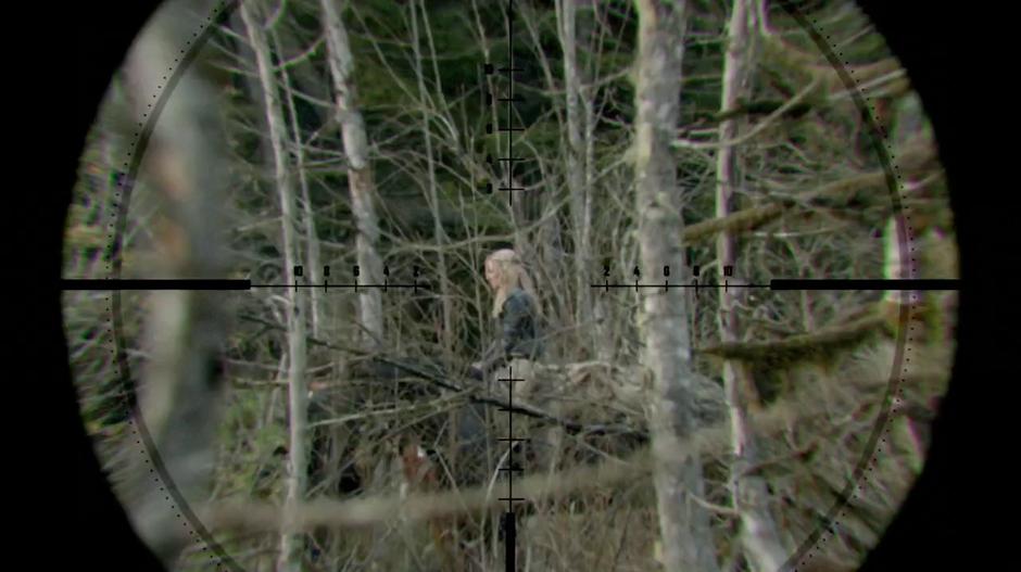 Clarke sits on her horse in the rifle scope of the sniper.