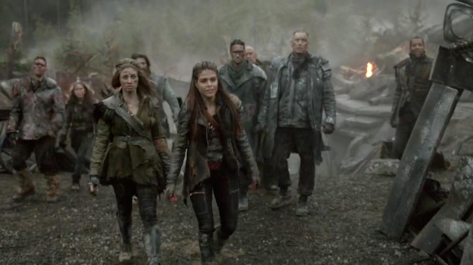 Octavia walks up to the people who have come to help from Camp Jaha.