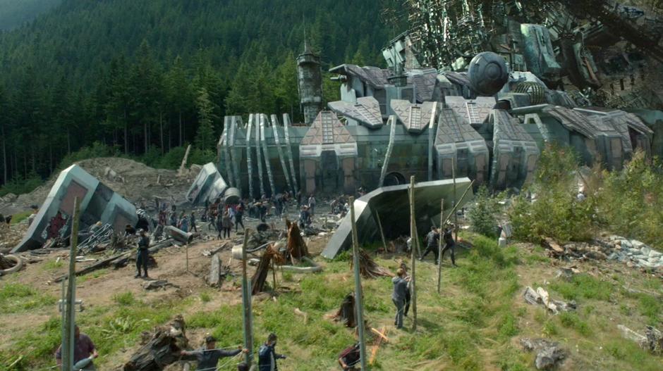 Ark survivors work on the new fence around the camp.