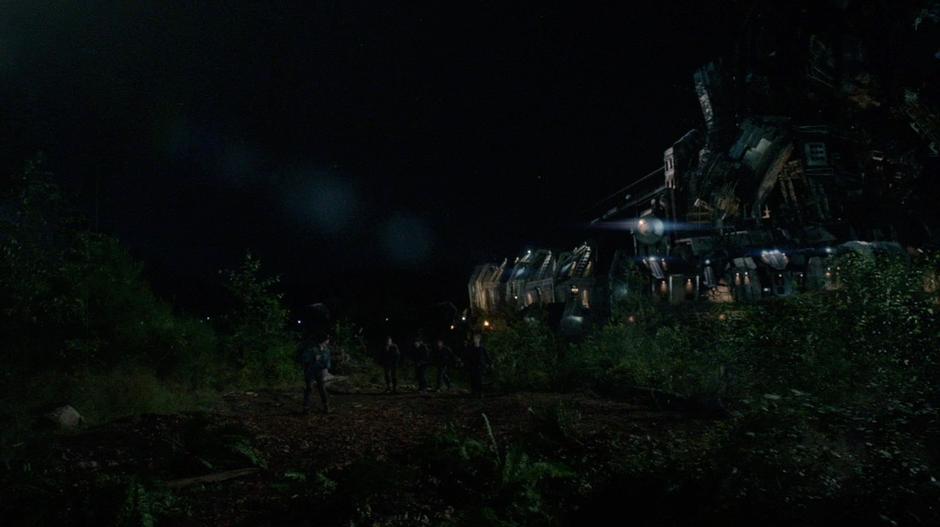 Bellamy and the others sneak out of camp at the night in their search for the missing 48.