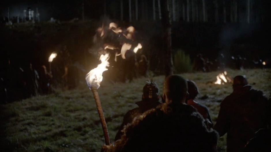 The Grounders escort Finn up to the execution post.