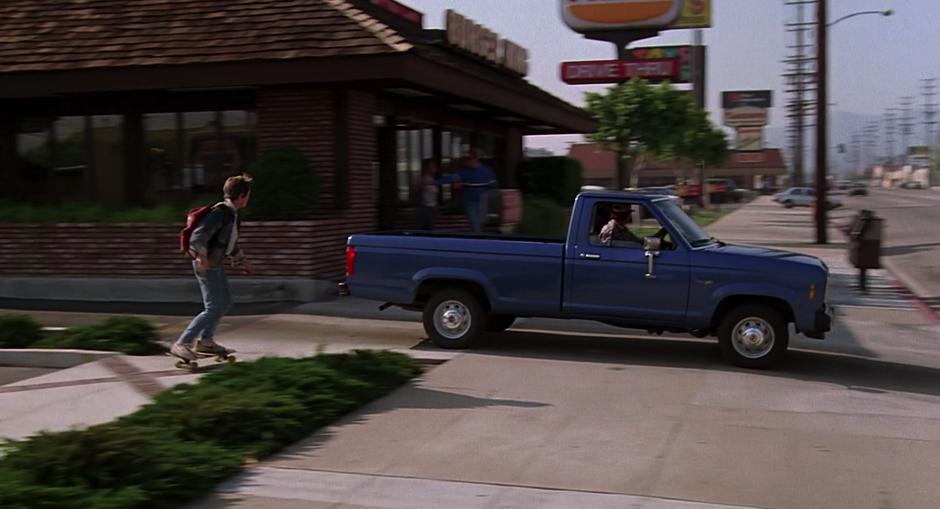 Marty skateboards past the Burger King outside Doc Brown's house.