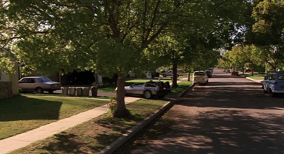 Doc drives the DeLorean out of Marty's driveway in 1985.