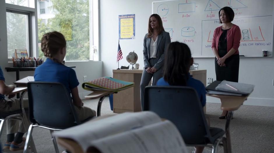 Vivian Stoll stands at the front of the class with the teacher and informs them that Wally Reid has died.