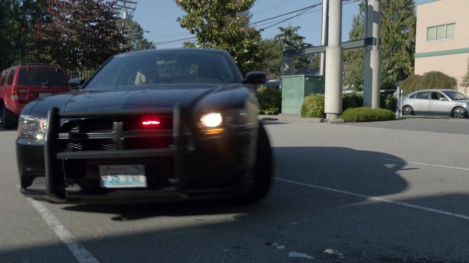 Clive pulls his cruiser into the parking spot out front of the radio station.