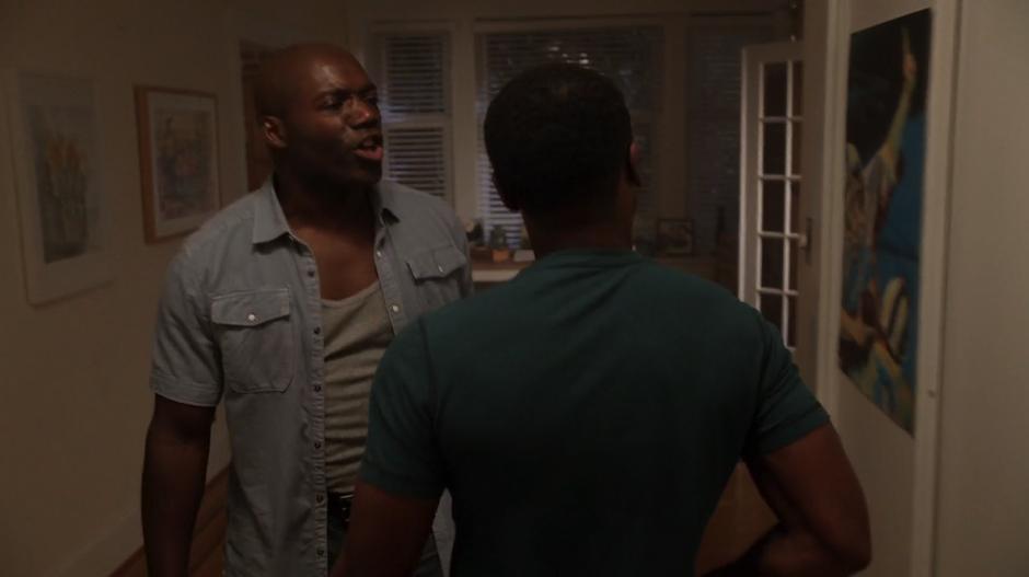 Clive pushes into the room where Anna is on the floor while Wally's abusive father tries to stop him.