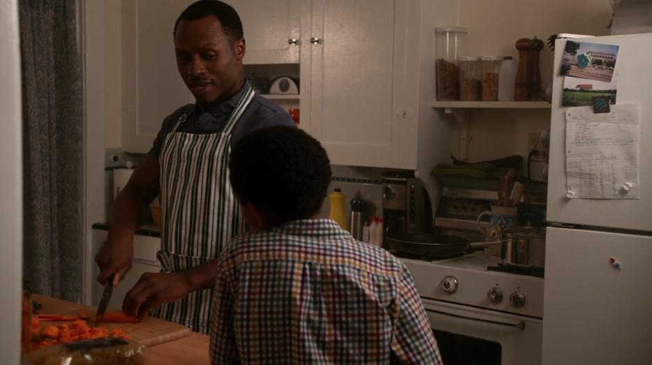 Clive shows Wally a neat trick with the knife while cutting carrots.