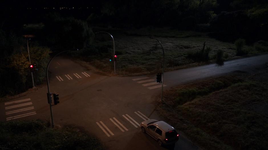 Cindy & Stanley Chen's car pulls up to the red light at a remote intersection.