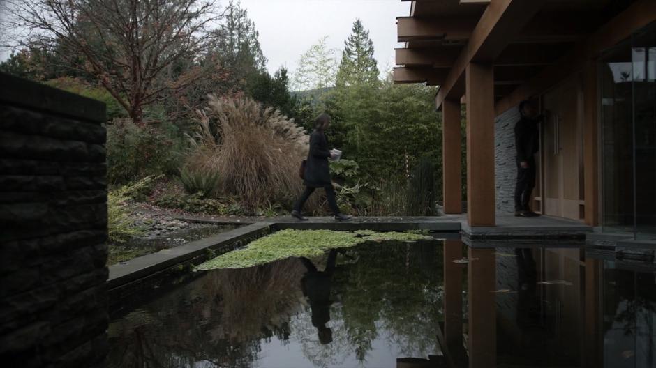 Quentin walks up to the door of the house while Eliot knocks.