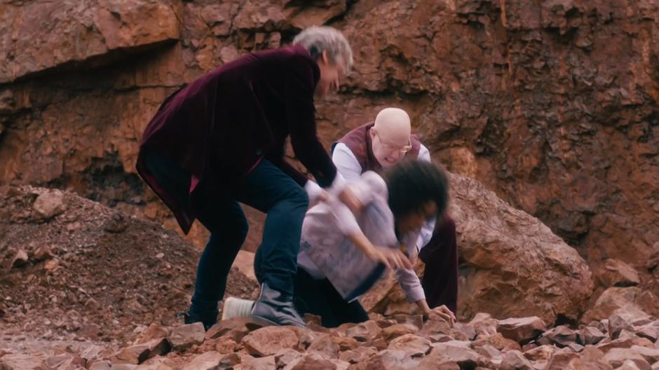 The Doctor and Nardole pull Bill away from the puddle that was grabbing her.