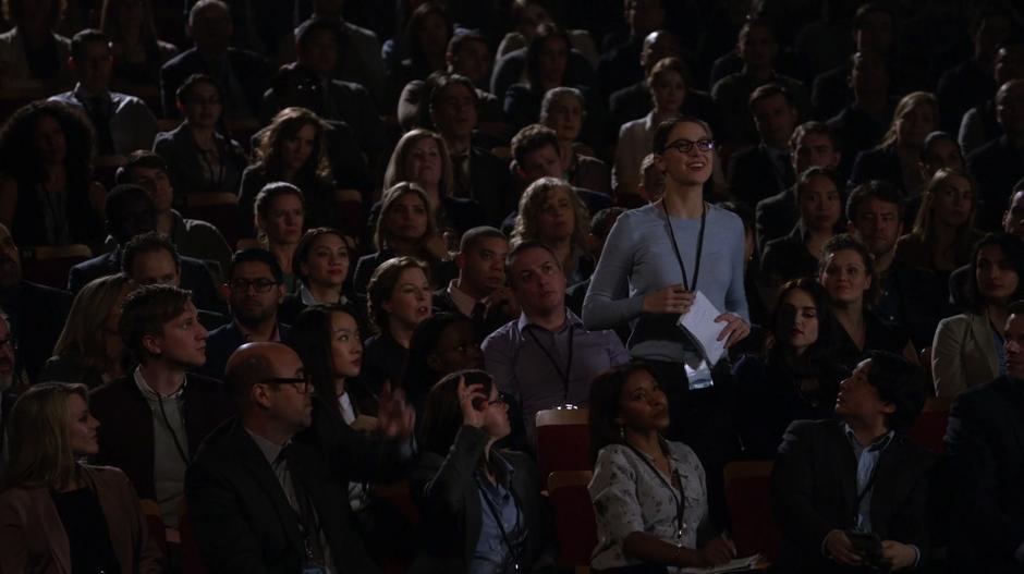 Kara stands up to ask a question in the audience.