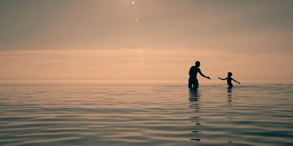 Luke and Hannah play in the shallow water of the ocean.